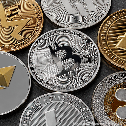 Image of Different coins of crypto currency on a black background. Business concept.