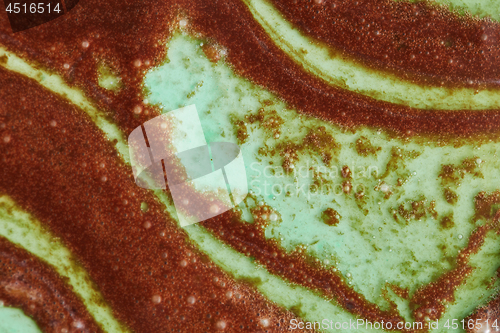 Image of Close up of abstract background from melted chocolate and mint sorbet.