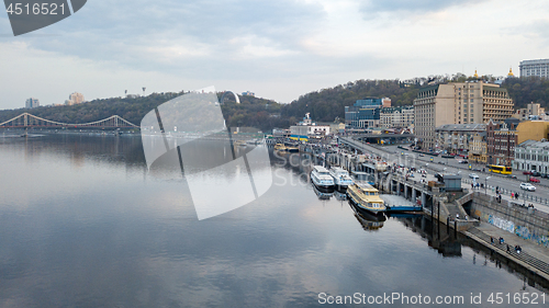 Image of View of the pedestrian bridge, the Vladimirskaya Hill with the monument of the Arco-Soviet of the People, the river Dnipro and tourist parades in Kyiv