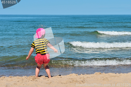 Image of Small kid play with sand