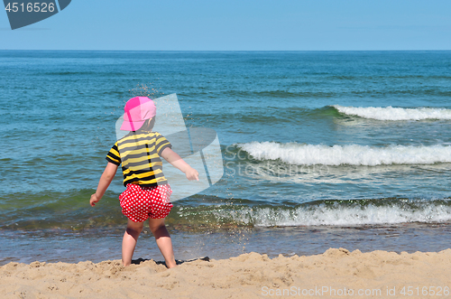Image of Small kid play with sand