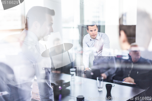 Image of Business team brainstorming on meeting in modern corporate office.