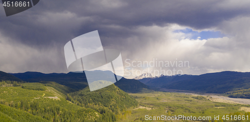 Image of Mt St Helens Peaks out from between the clouds in Washington Sta