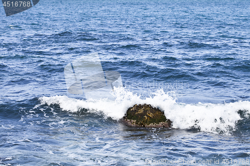 Image of Waving water surface and stone of the Adriatic sea.