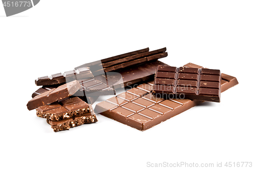 Image of Heap of broken dark and milk chocolate bars with hazelnuts.