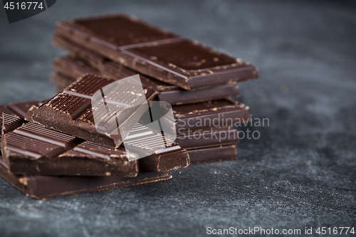 Image of Dark chocolate bar pieces closeup. Sweet food photo concept. 
