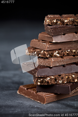 Image of Chocolate bar pieces closeup. Sweet food photo concept with copy