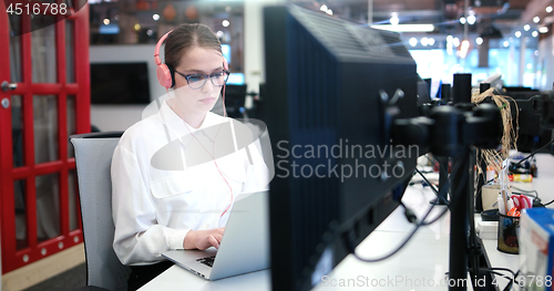 Image of businesswoman using a laptop in startup office