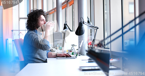 Image of businessman working using a laptop in startup office