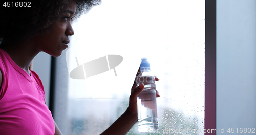 Image of portrait of young afro american woman in gym on workout break