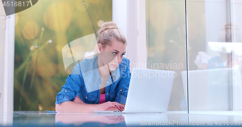 Image of young women using laptop computer on the floor