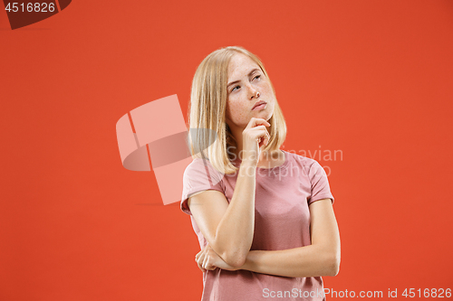 Image of Young serious thoughtful blonde with freckles woman. Doubt concept.