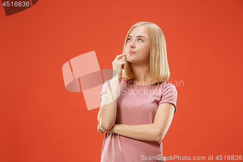 Image of Young serious thoughtful blonde with freckles woman. Doubt concept.