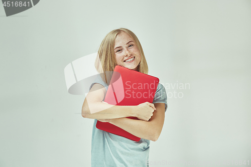 Image of Businesswoman hugging laptop. Love to computer concept. Attractive female half-length front portrait