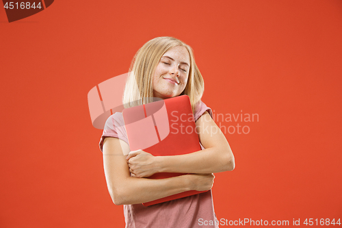 Image of Businesswoman hugging laptop. Love to computer concept. Attractive female half-length front portrait