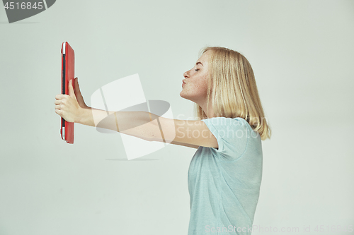 Image of Businesswoman hugging laptop. Love to computer concept. Attractive female half-length front portrait