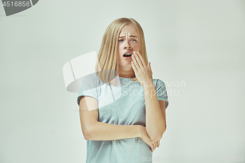 Image of Beautiful bored woman bored isolated on gray background