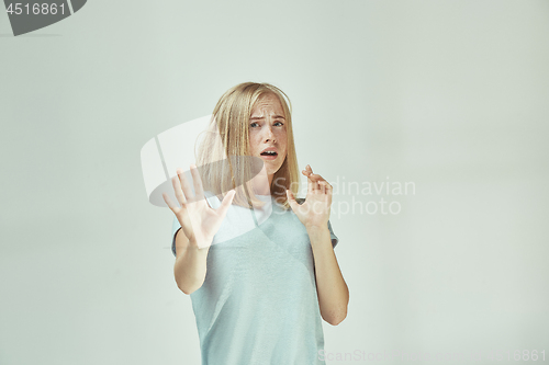 Image of Portrait of the scared woman on gray