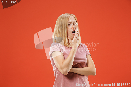 Image of Beautiful bored woman bored isolated on red background