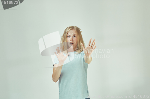 Image of Portrait of the scared woman on gray