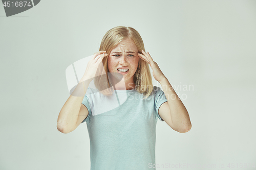 Image of Woman having headache. Isolated over pastel background.