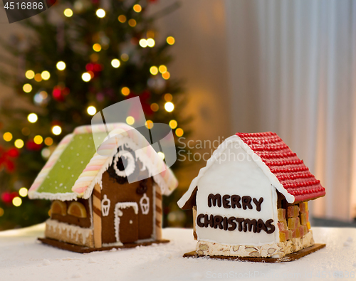 Image of gingerbread houses over christmas tree lights