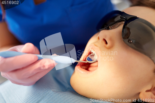 Image of boy having teeth checkup at dental clinic