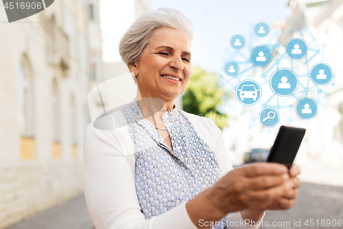 Image of senior woman with smartphone and car sharing icons