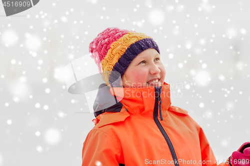 Image of happy little girl in winter clothes outdoors