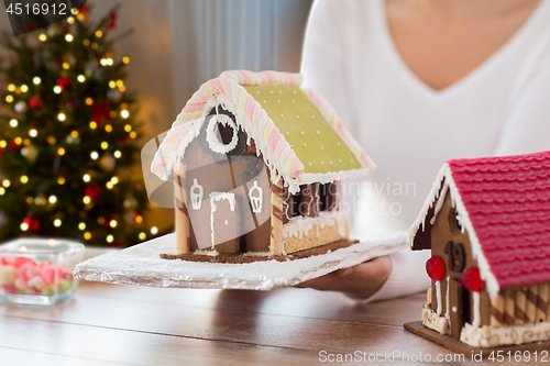 Image of close up of woman with christmas gingerbread house