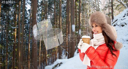 Image of woman in fur hat with coffee over winter forest