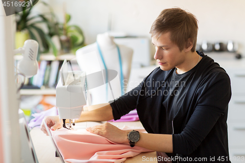 Image of fashion designer with sewing machine working