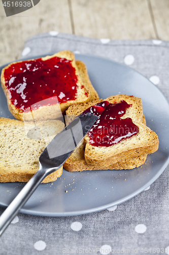 Image of Fresh toasted cereal bread slices with homemade cherry jam and k