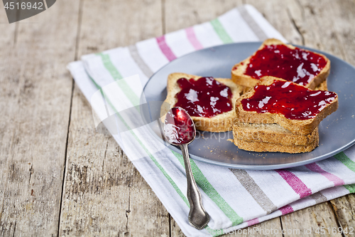 Image of Fresh toasted cereal bread slices with homemade cherry jam and s