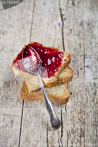 Image of Toasted cereal bread slices stack with homemade cherry jam and s