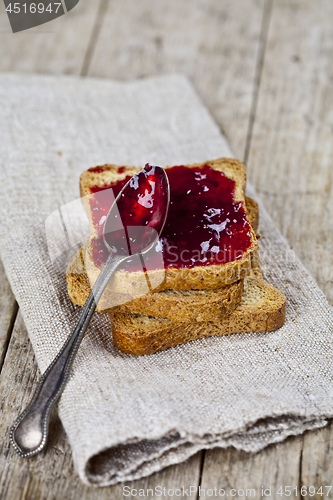 Image of Toasted cereal bread slices stack with homemade cherry jam and s