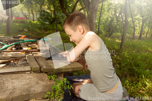 Image of Boy playing on tablet