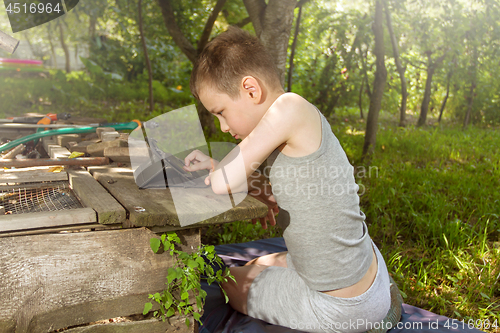 Image of Boy playing on tablet