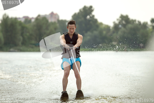 Image of Man riding water skis