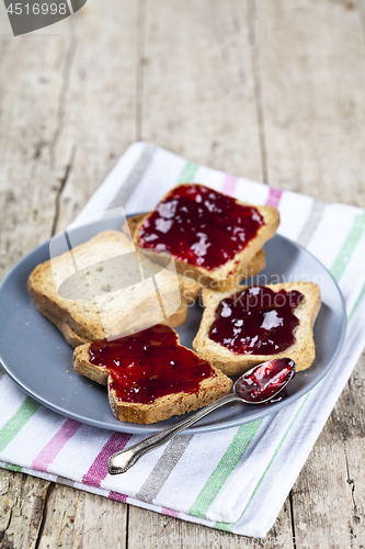 Image of Fresh toasted cereal bread slices with homemade cherry jam and s