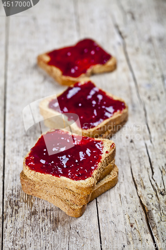 Image of Toasted cereal bread slices with homemade cherry jam closeup on 