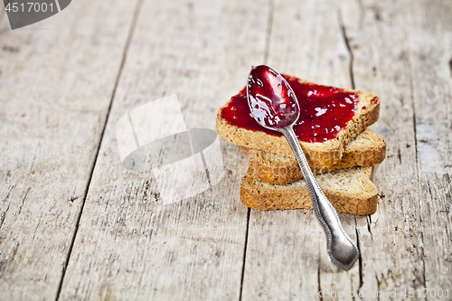 Image of Toasted cereal bread slices stack with homemade cherry jam and s
