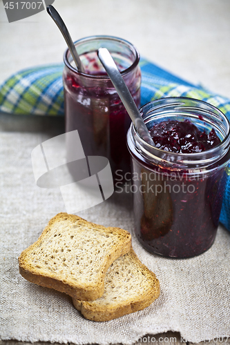 Image of Toasted cereal bread slices on blue ceramic plate and homemade c