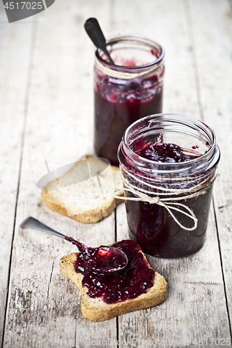 Image of Cereal fresh bread toasts slices and jars with homemade wild ber