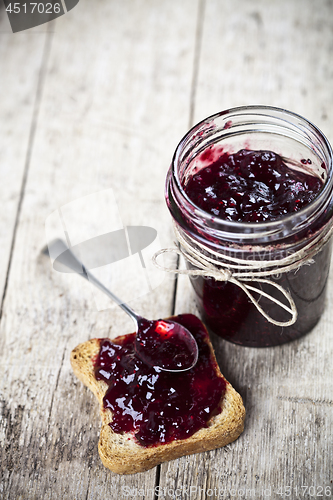 Image of Toasted cereal bread slices and homemade wild berries jam in jar
