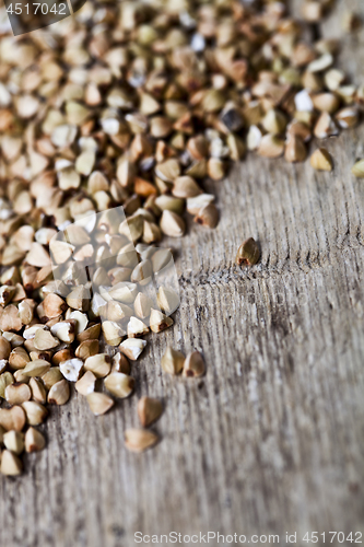 Image of Fresh green dry buckwheat seads closeup on rustic wooden backgro