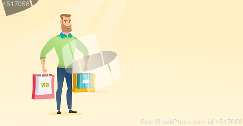 Image of Young happy caucasian man with shopping bags.