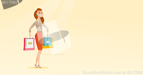 Image of Young happy caucasian woman with shopping bags.