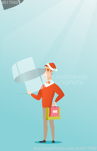 Image of Man in santa hat shopping for christmas gifts.
