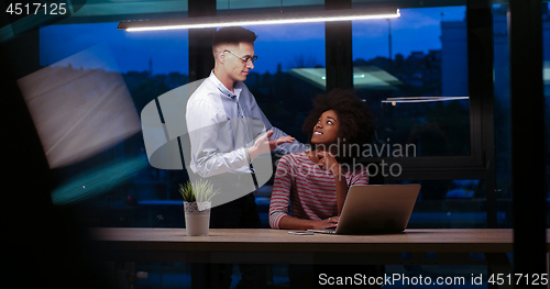 Image of Multiethnic startup business team in night office